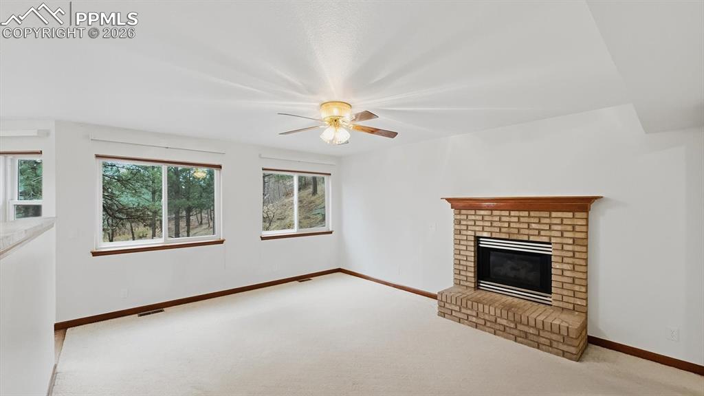 Image 17 of 47: The formal dining room has neutral carpet, an attractive light fixture, a w