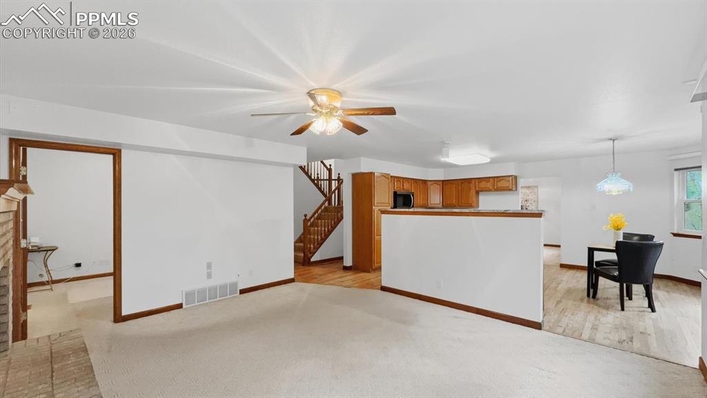 Image 18 of 47: The updated island kitchen features wood cabinetry, newer granite counterto