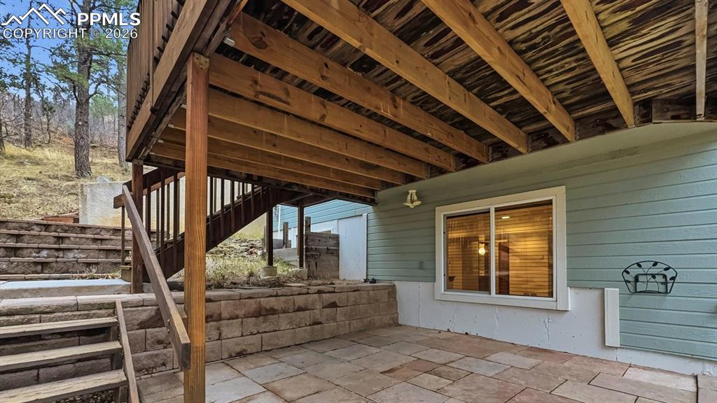 Image 42 of 47: Wood deck and flagstone patio for outdoor dining, entertaining, and relaxat