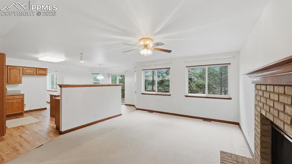 Image 6 of 47: The formal living rm is highlighted by a dramatic arched window framing stu