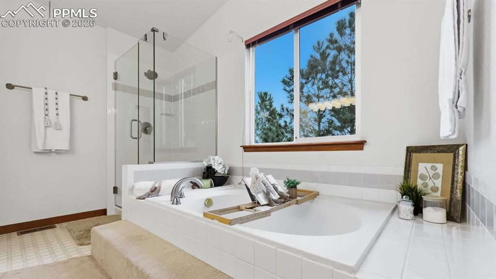 Image 8 of 47: The family room is warm & inviting with a lighted ceiling fan, wall of wind