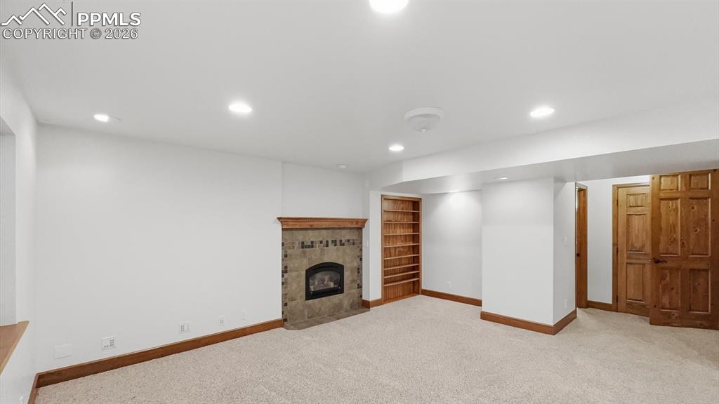 Image 9 of 47: The vaulted primary suite serves as a private retreat with a ceiling fan, e