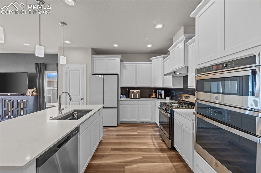 Image 16 of 49: Modern kitchen featuring an island with an undermount sink, stainless steel