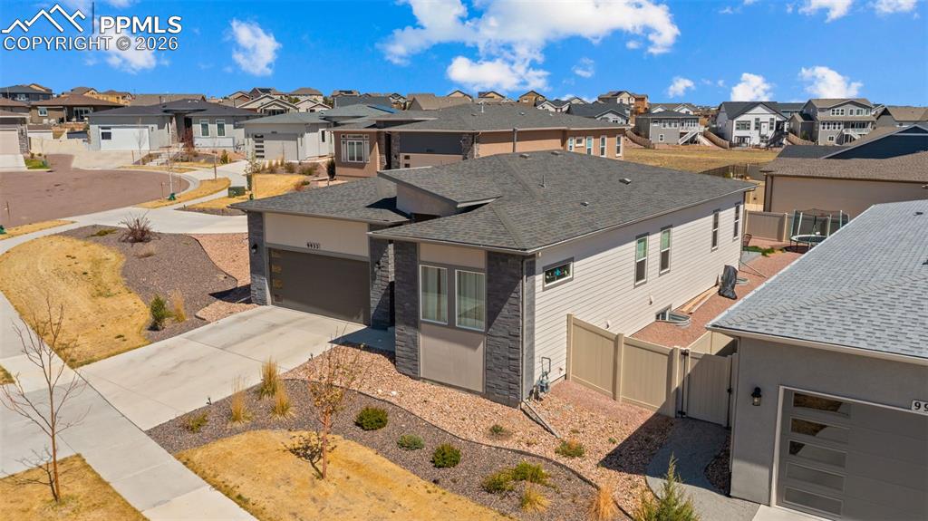 Image 38 of 49: Modern residence featuring a gray asphalt shingle roof, light-colored sidin