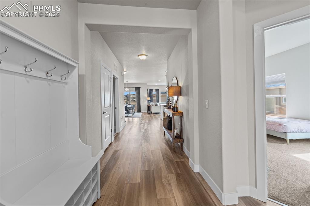 Image 6 of 49: Entryway featuring a built-in bench with coat hooks and cubby storage