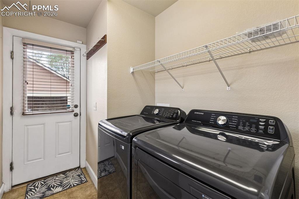 Image 14 of 27: Laundry on main level with walkout to backyard
