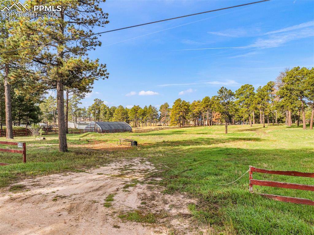 Image 6 of 9: View of yard with an outbuilding, a rural view, and an exterior structure