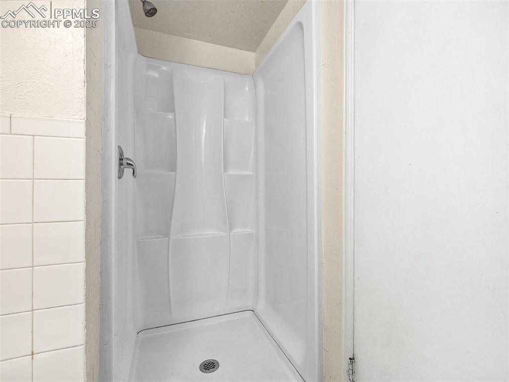 Image 13 of 28: Bathroom with a stall shower