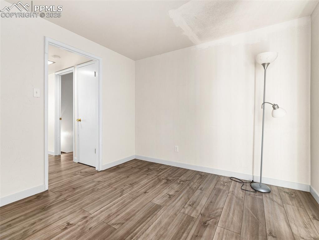 Image 15 of 28: Unfurnished room with light wood-type flooring and baseboards