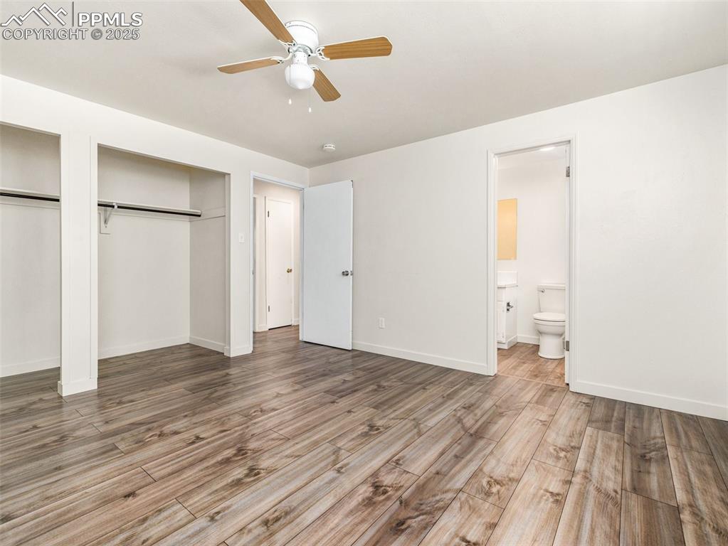 Image 24 of 28: Unfurnished bedroom featuring multiple closets, light wood-style floors, a