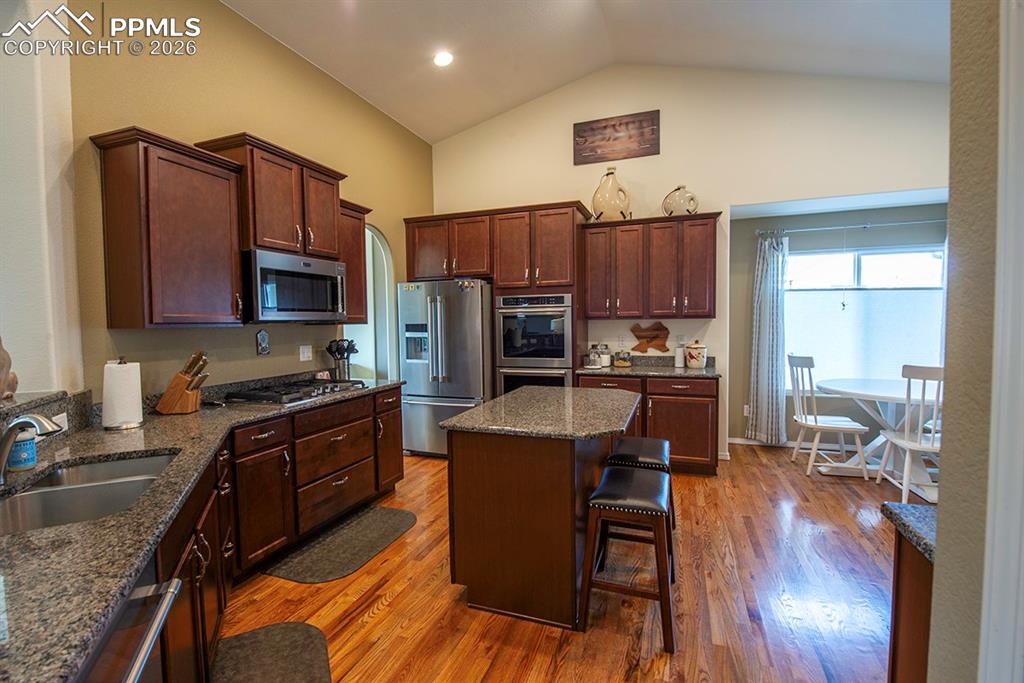 Image 17 of 47: Kitchen with additional area for seating and island