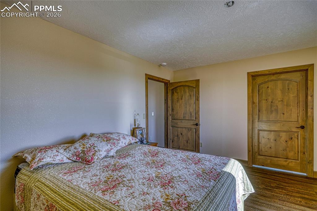 Image 34 of 50: Bedroom featuring a textured ceiling
