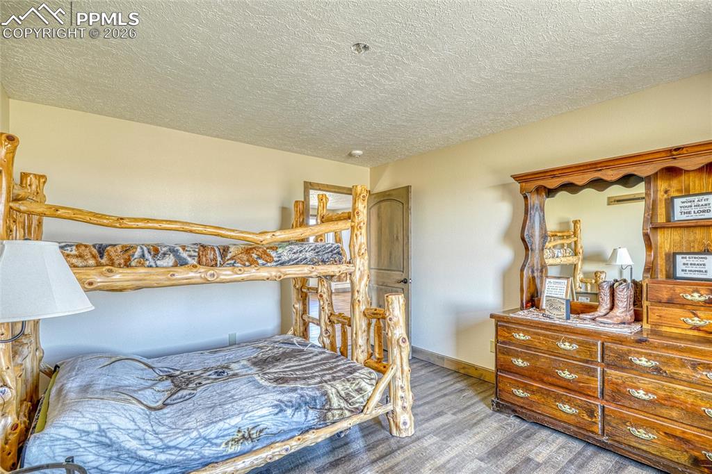 Image 37 of 50: Bedroom featuring a textured ceiling and baseboards