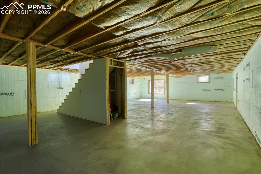 Image 44 of 50: Unfinished below grade area featuring stairs