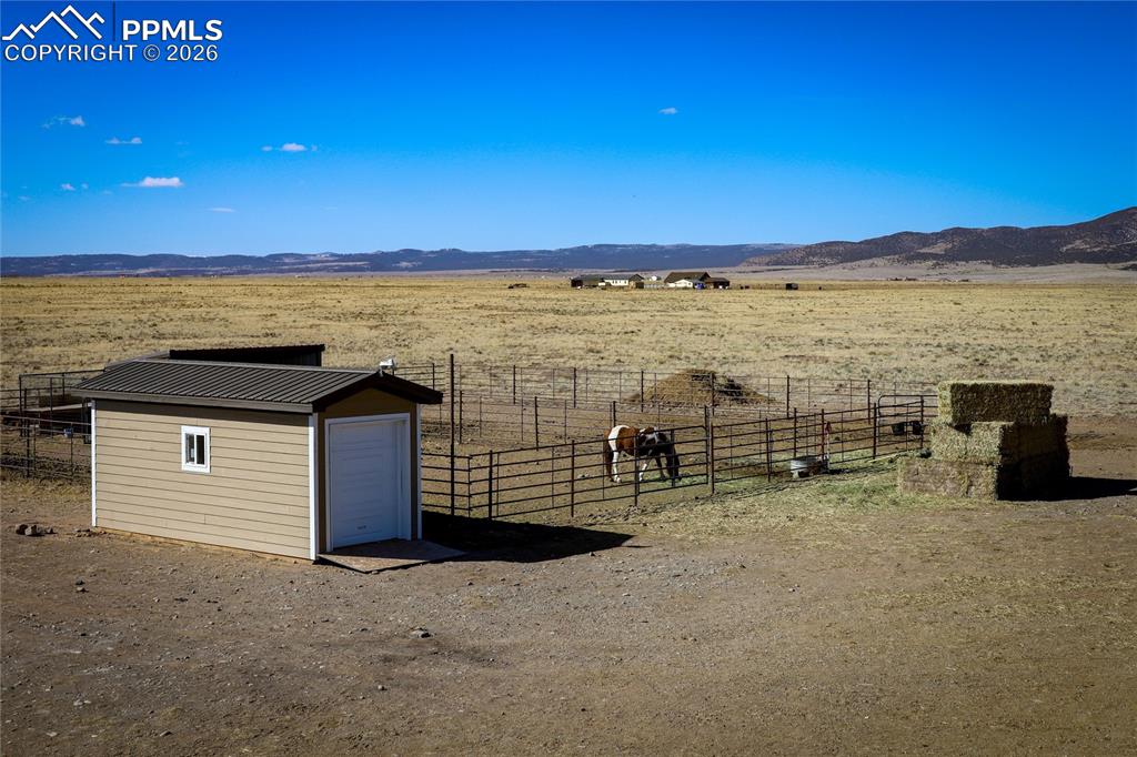 Image 49 of 50: Corral, loafing shed, & storage shed