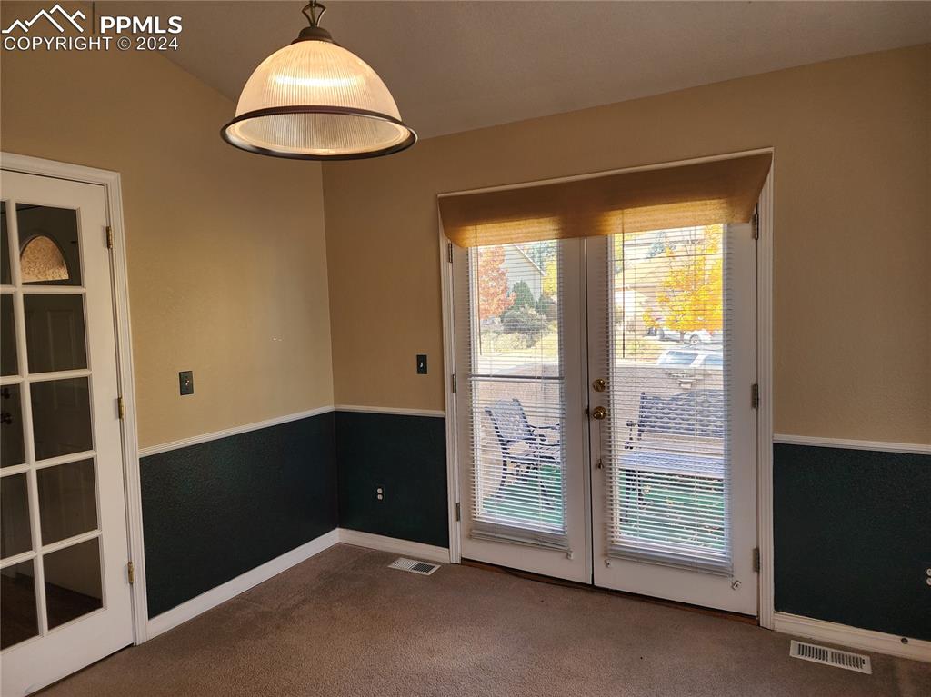 Image 15 of 49: Entryway with french doors and carpet