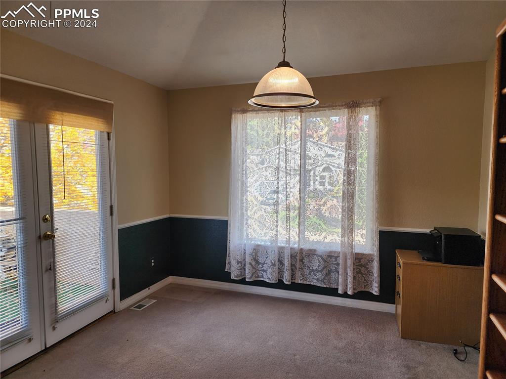 Image 16 of 49: Unfurnished dining area featuring carpet flooring