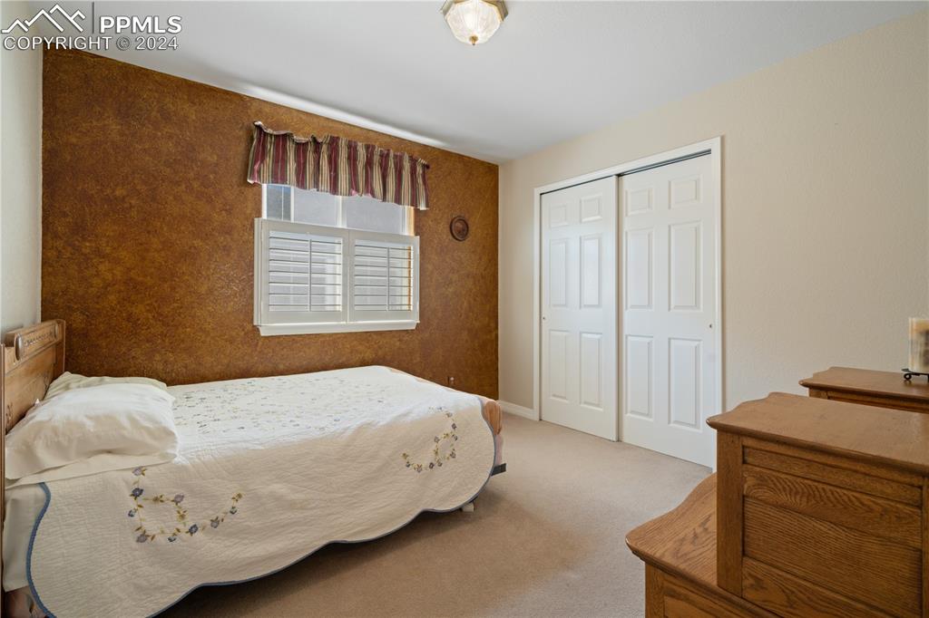 Image 28 of 49: Bedroom with a closet and carpet floors