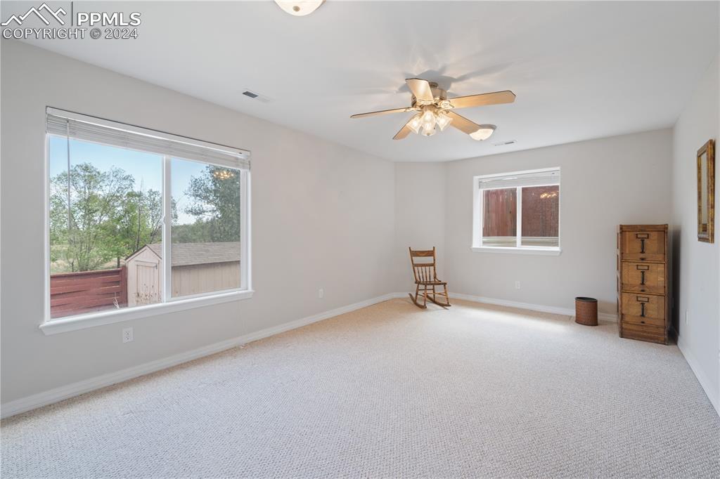 Image 29 of 49: Carpeted empty room with ceiling fan