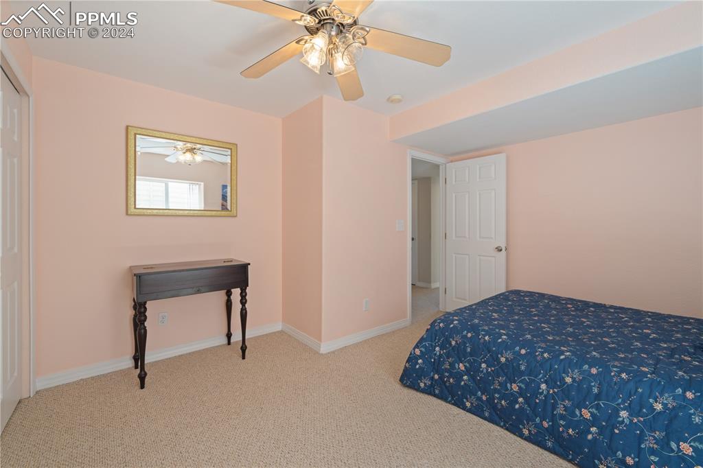 Image 32 of 49: Bedroom featuring ceiling fan and light carpet