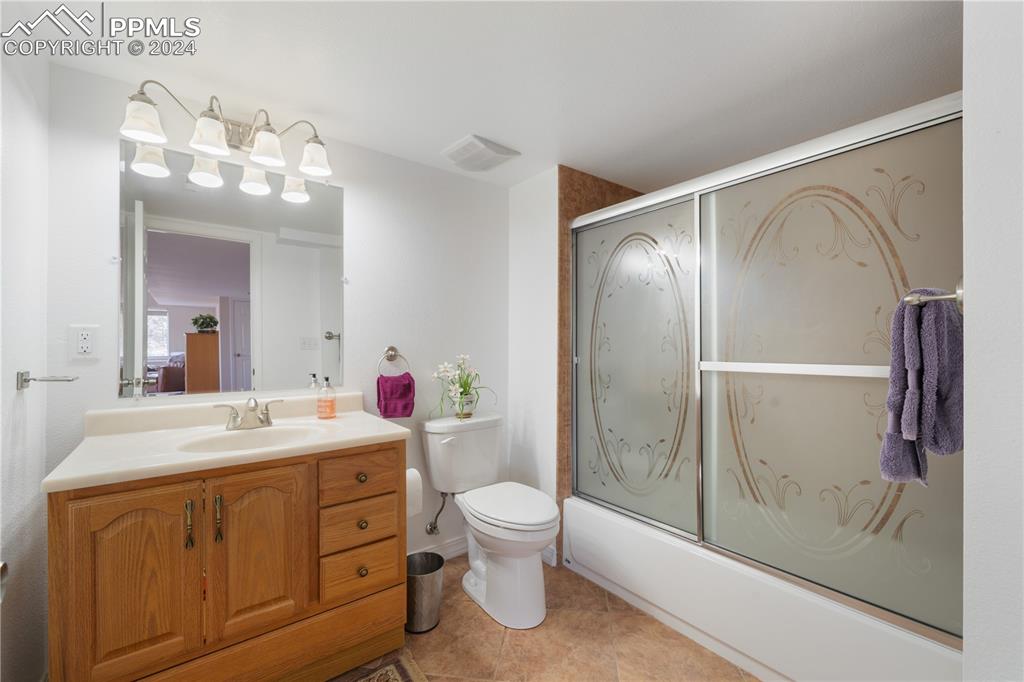 Image 35 of 49: Full bathroom featuring shower / bath combination with glass door, vanity, 