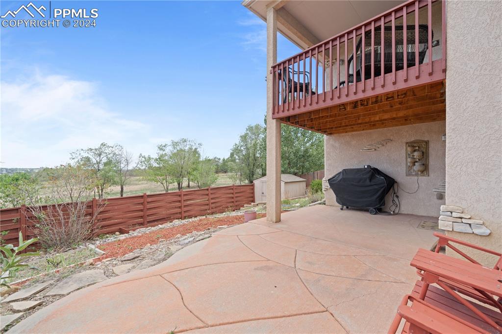 Image 43 of 49: View of patio featuring a grill and a storage shed