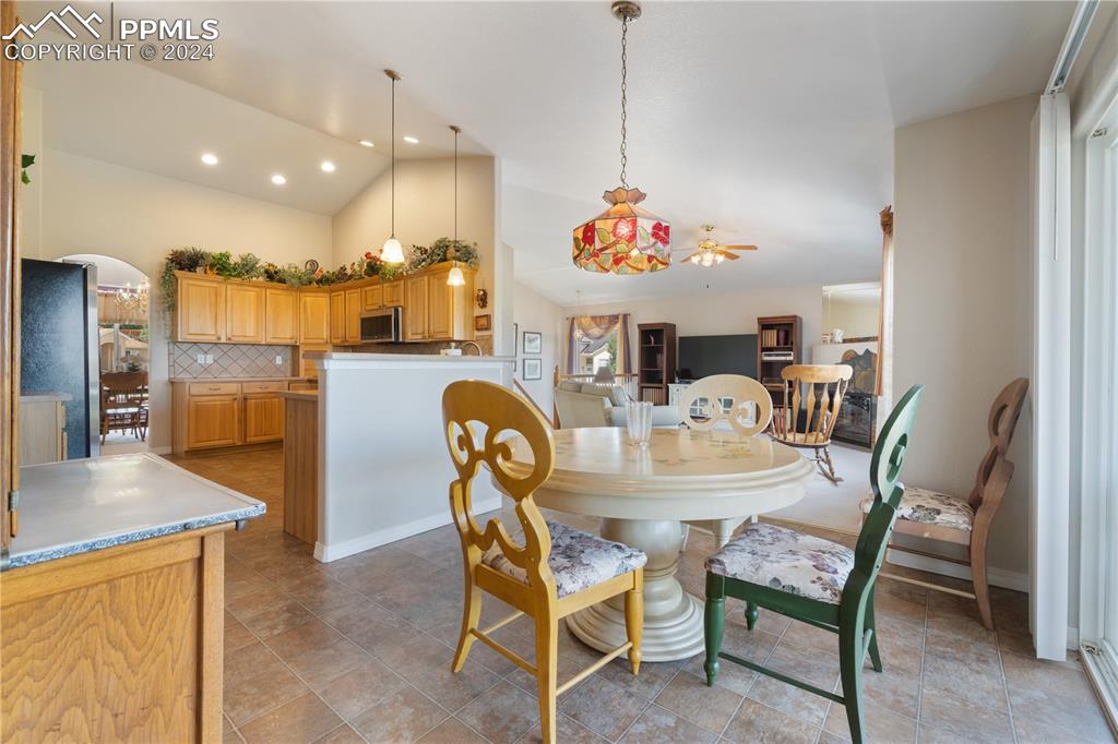 Image 8 of 49: Dining area featuring lofted ceiling and ceiling fan