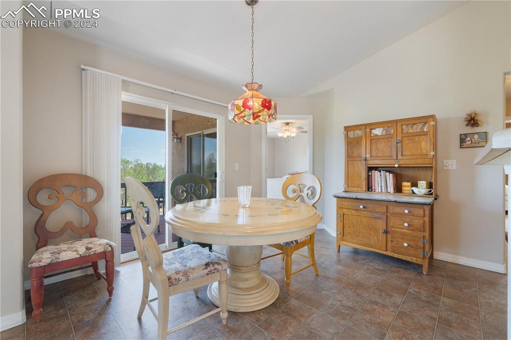 Image 9 of 49: Dining area featuring lofted ceiling