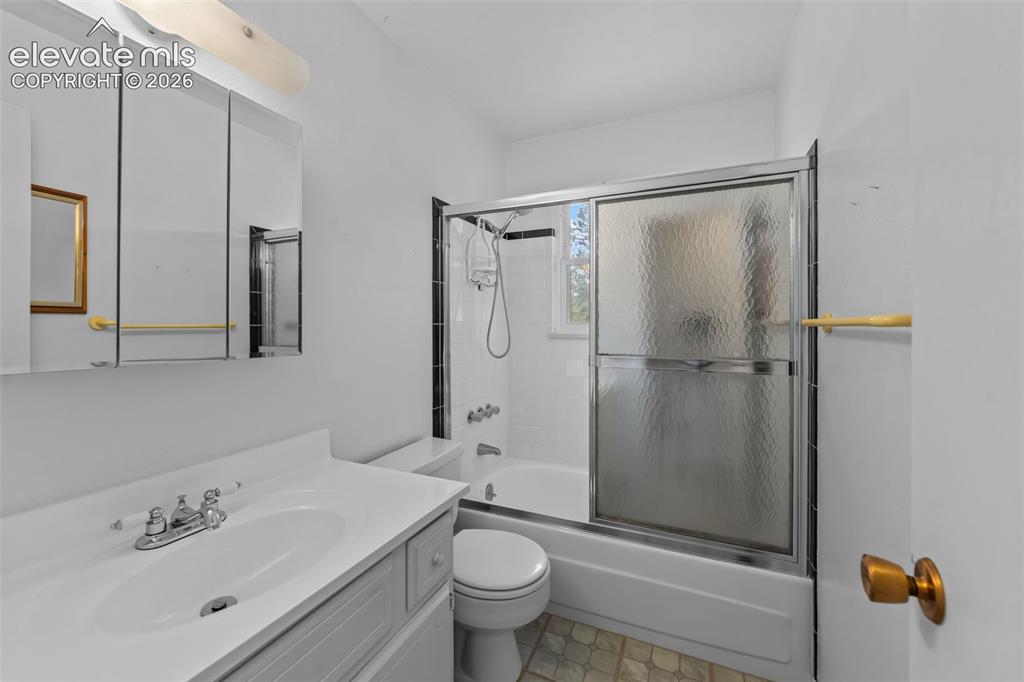 Image 11 of 35: White vanity with integrated sink, three-door mirrored medicine cabinet, wh