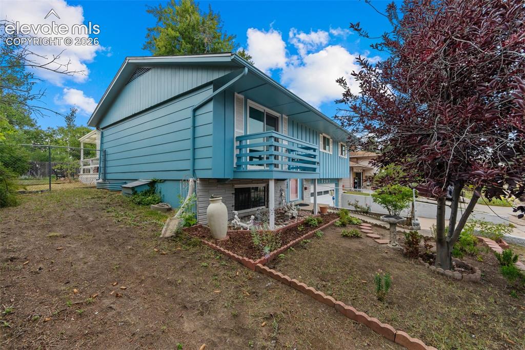 Image 3 of 35: Exterior with light blue siding, white trim, and a second-story balcony
