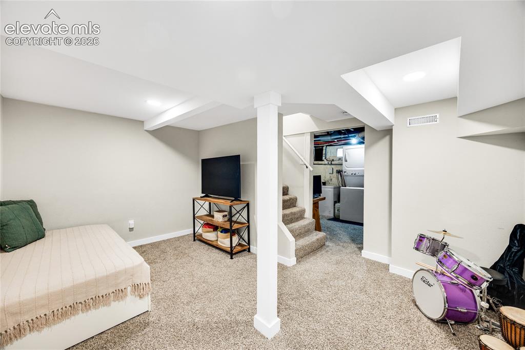 Image 18 of 33: Basement Recreation Room with carpet floorings