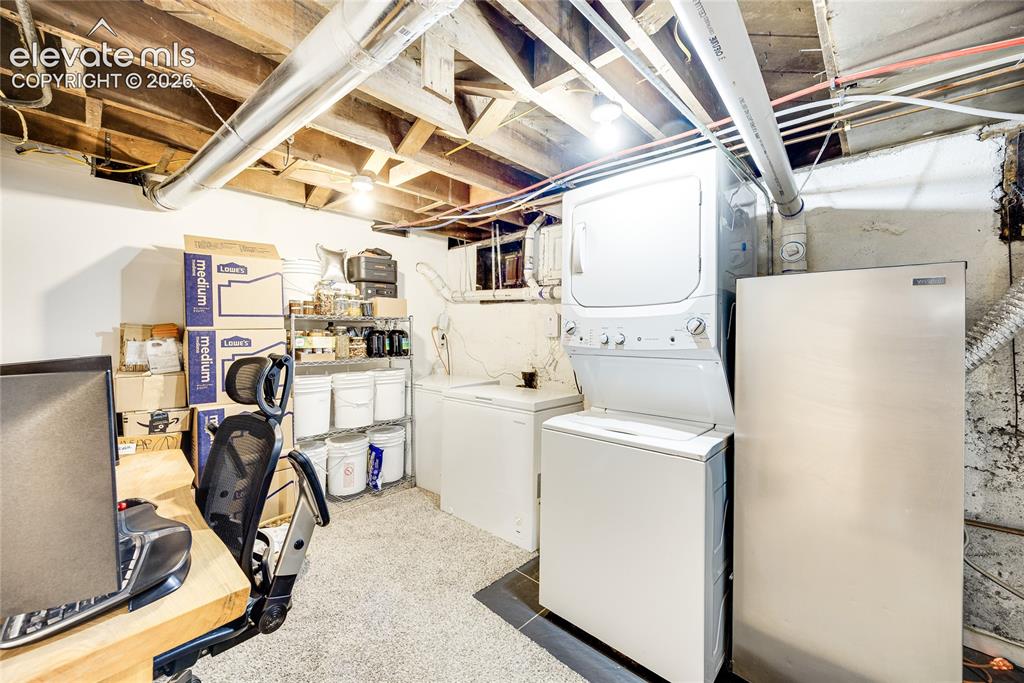 Image 19 of 33: Unfinished Basement Area with Laundry