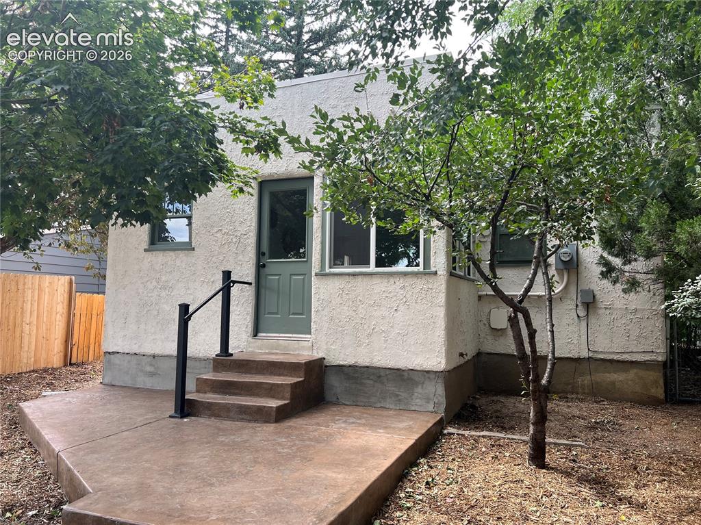 Image 21 of 33: Main House - rear yard with stamped concrete patio