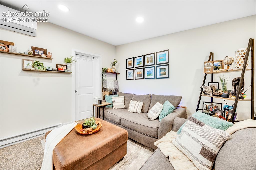 Image 25 of 33: ADU/Cottage -Recessed lighting, light-colored walls, and carpeted flooring