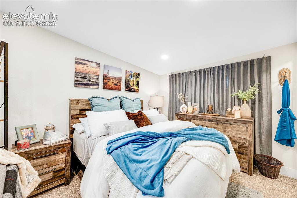Image 28 of 33: ADU/Cottage - Recessed lighting, light-toned walls, and neutral carpeting