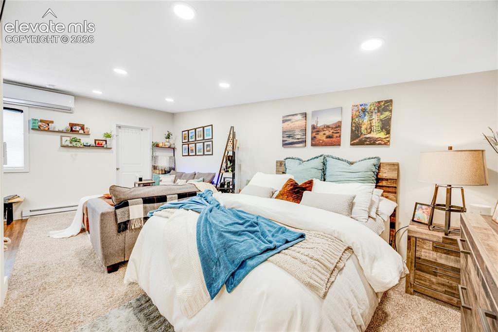 Image 29 of 33: ADU/Cottage - Recessed lighting, light-toned walls, and neutral carpeting