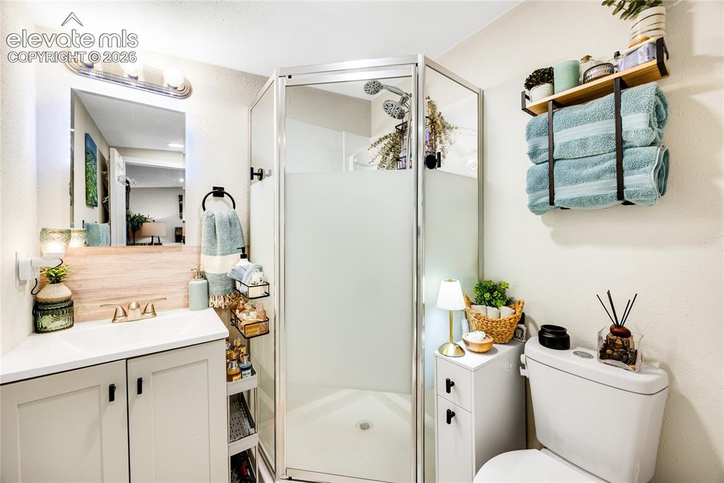 Image 30 of 33: ADU/Cottage - Enclosed shower with frosted glass, single vanity with light-