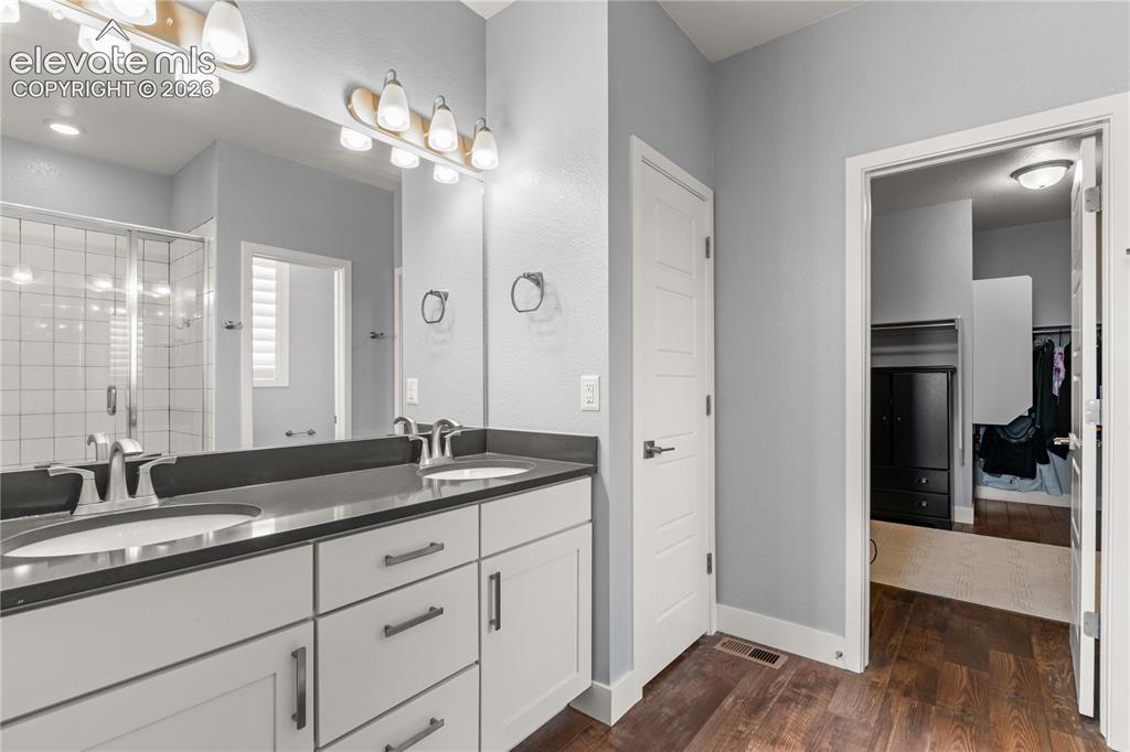 Image 17 of 41: Dual vanities, quartz countertops, and a huge walk in closet.