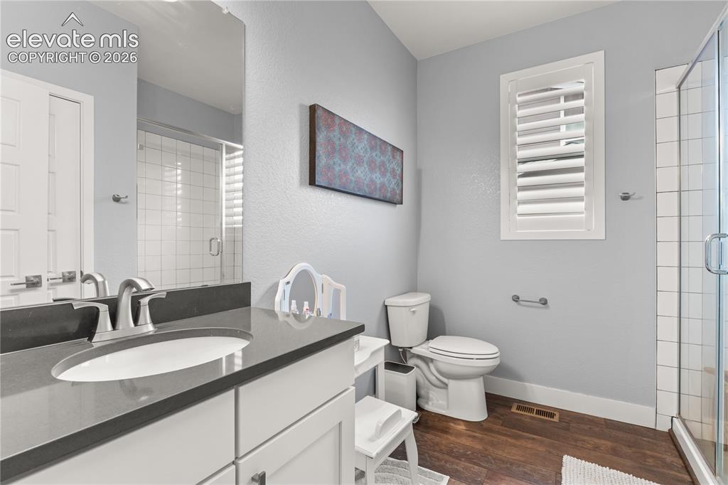 Image 21 of 41: Main level bathroom with subway tile and quartz for the upper level bedroom