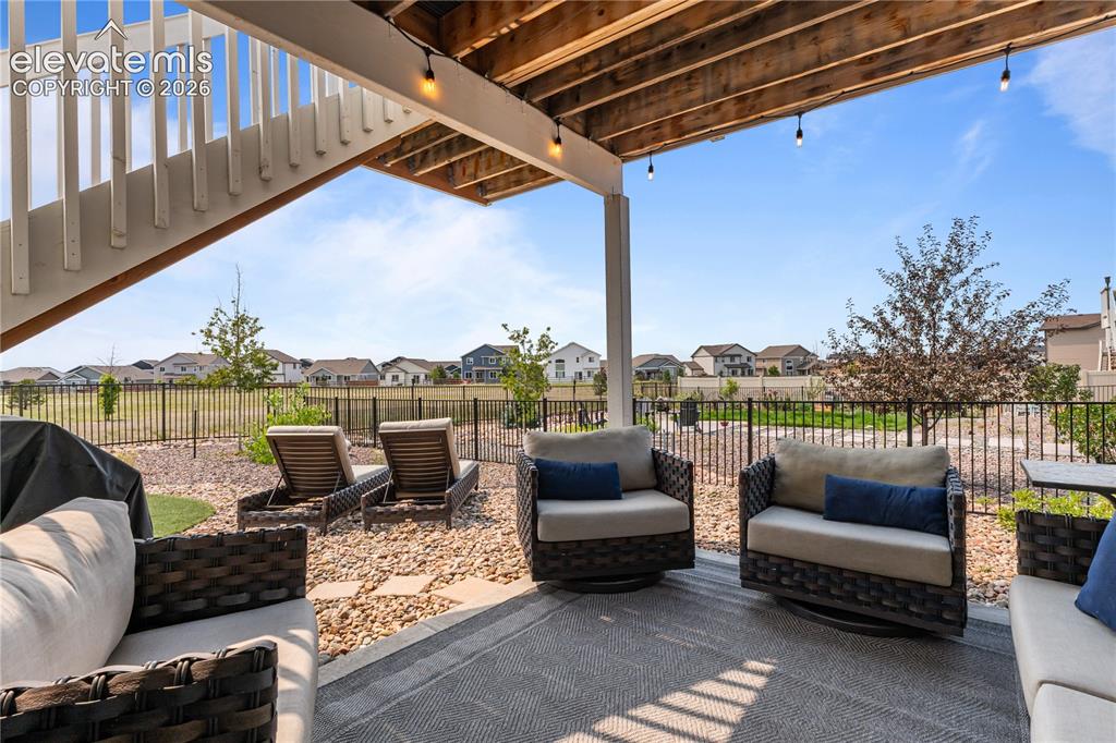 Image 32 of 41: Lower level patio overlooking the open space.