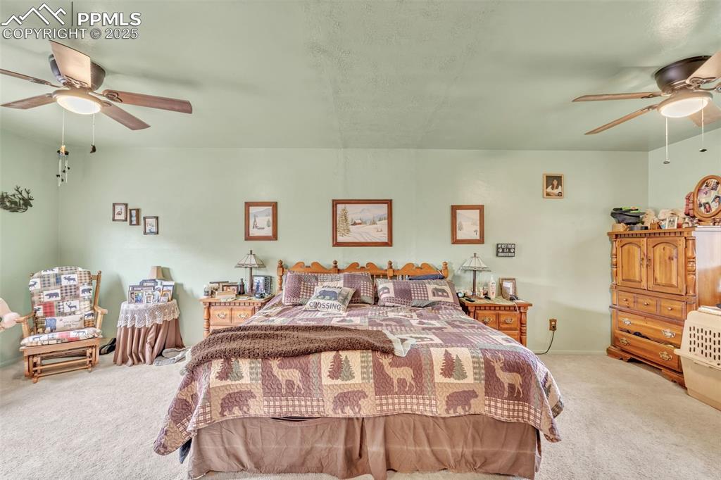 Image 21 of 49: Bedroom featuring light colored carpet and ceiling fan