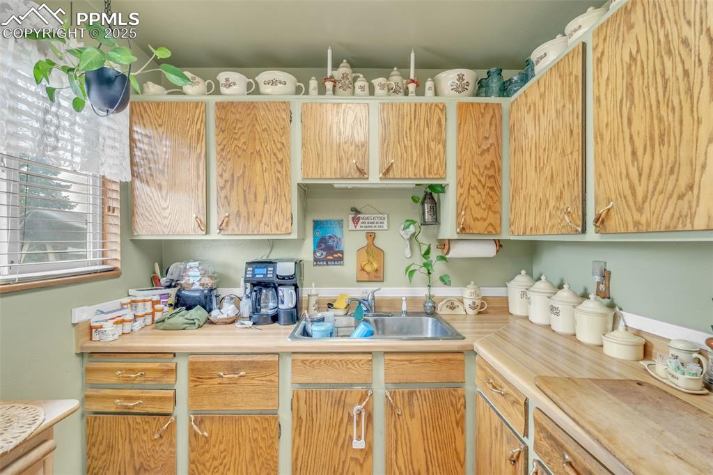 Image 25 of 49: Kitchen with light countertops and a sink