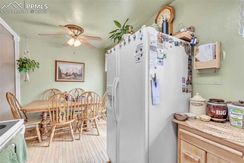 Image 28 of 49: Kitchen with white fridge with ice dispenser, hardwood / wood-style floors,