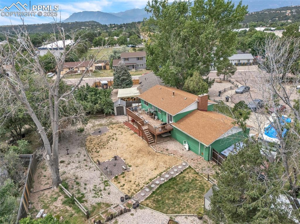 Image 47 of 49: Aerial perspective of suburban area featuring a mountain backdrop