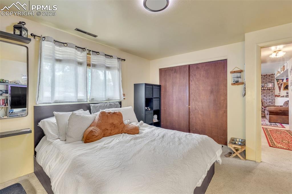 Image 6 of 49: Bedroom with carpet and a closet