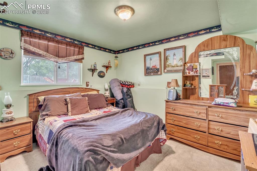 Image 7 of 49: Bedroom featuring light colored carpet