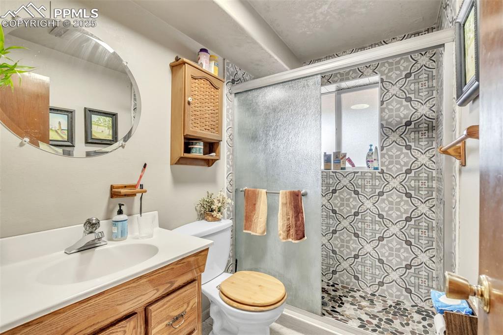 Image 8 of 49: Full bathroom with vanity and a stall shower