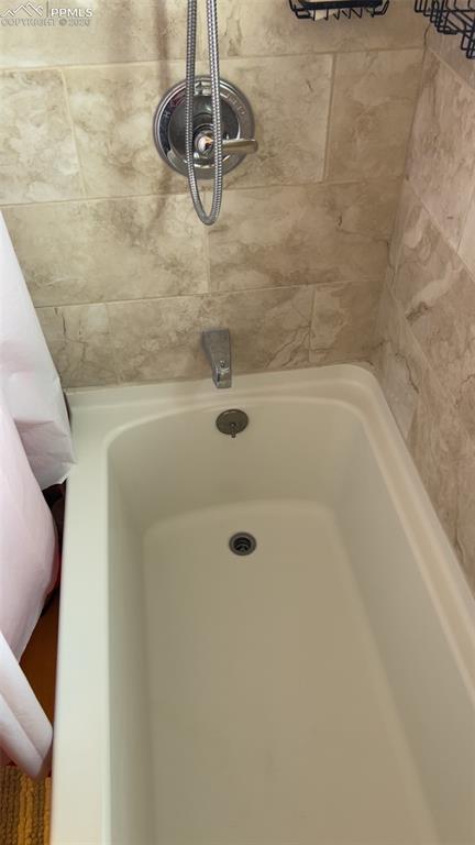 Image 13 of 35: Bathtub in full bathroom upstairs
