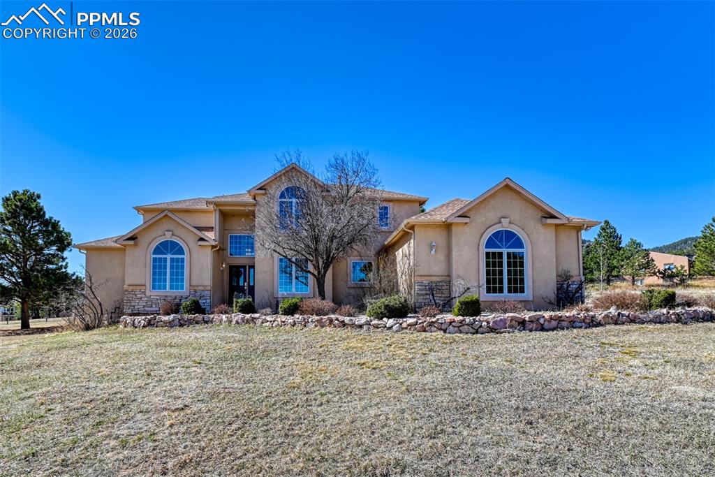 Caption: Located on 2.28 acres, this stucco two-story custom-built home boasts a main level master. 