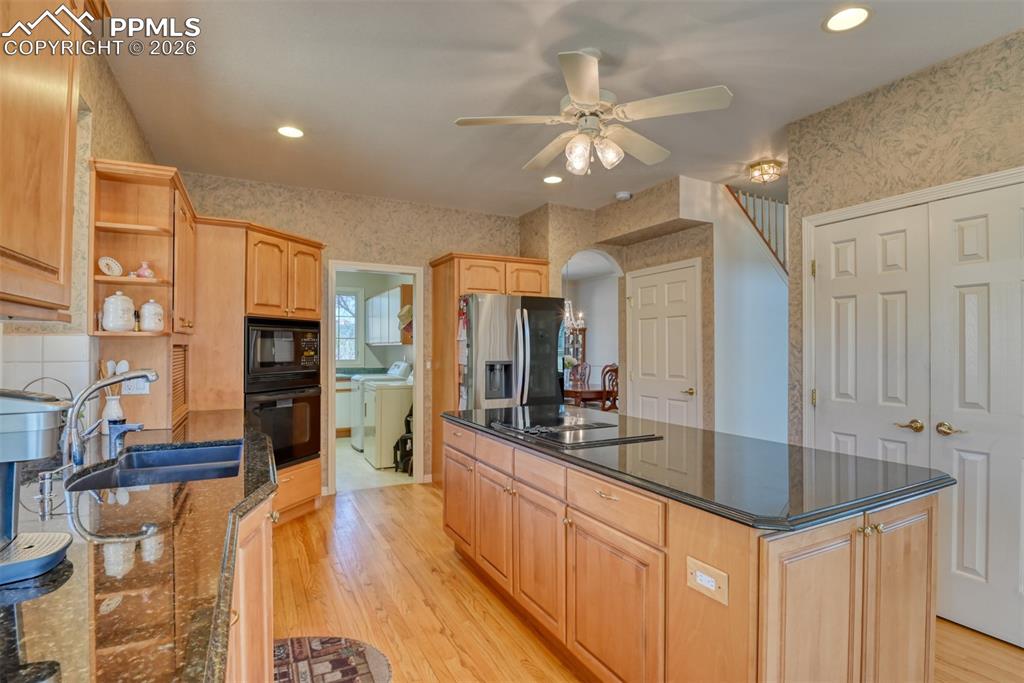 Image 11 of 47: Hardwood floors throughout the kitchen and leads to the front door. 